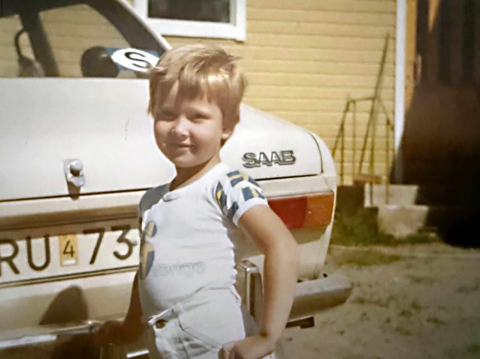 A child standing next to a car